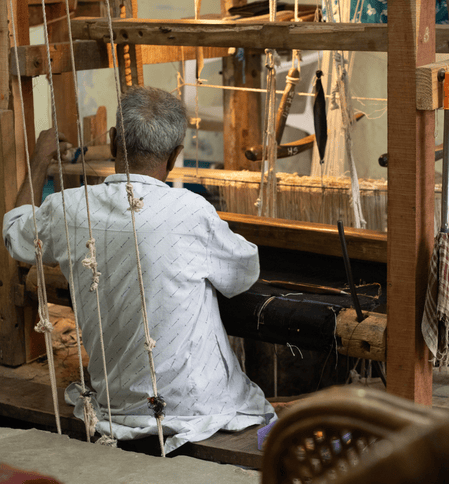 Artisan weaving authentic Himroo fabric on traditional pit loom Aurangabad Himroo Factory