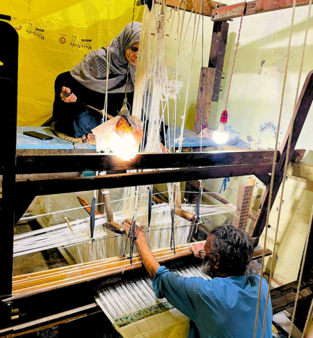 Artisan weaving authentic Himroo fabric on traditional pit loom Aurangabad Himroo Factory